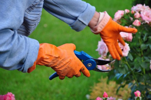 Worker using protective equipment during landscaping tasks